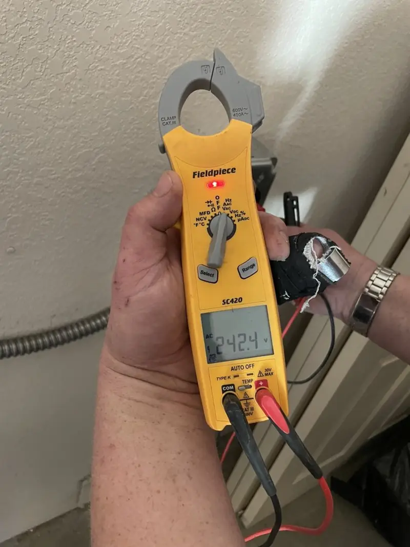 Voltage testing with clamp meter during Outlet Installation in El Campo